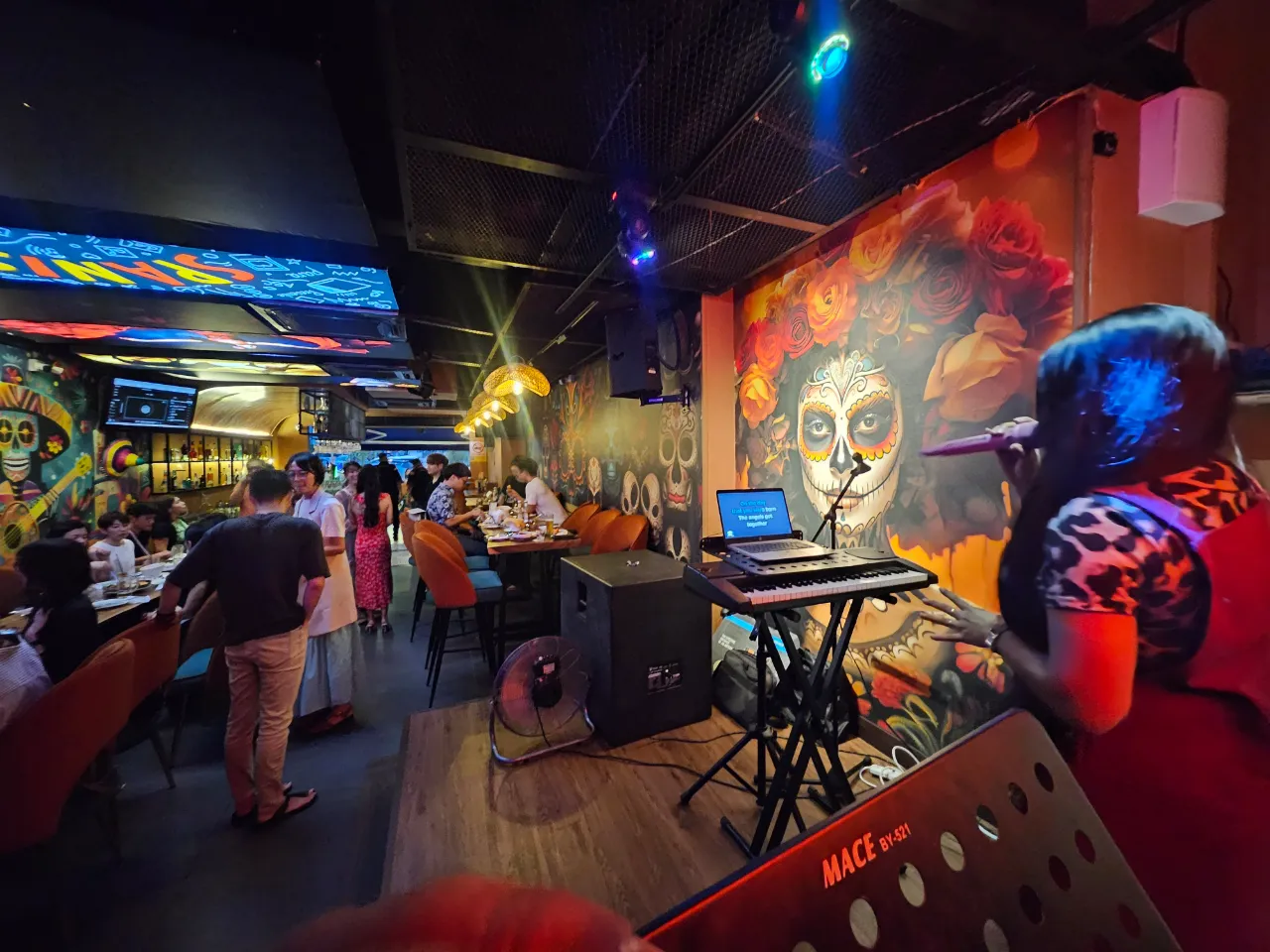 Full La Vida dining room at night — packed, neon-lit, live band set up