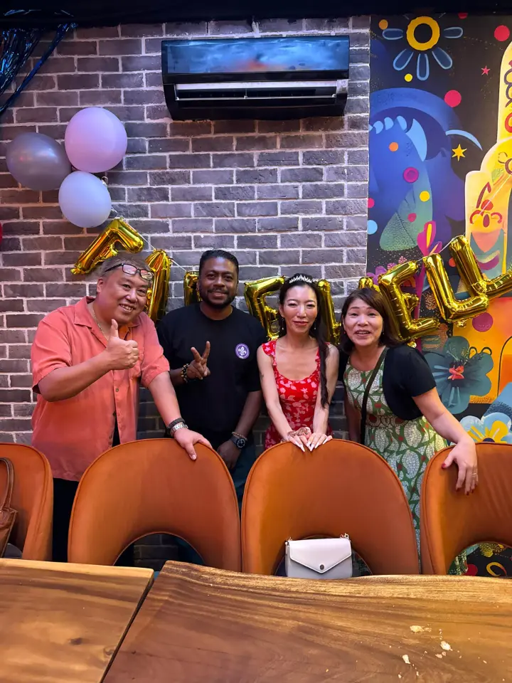 Guests dressed up under colourful neon at La Vida, celebratory atmosphere
