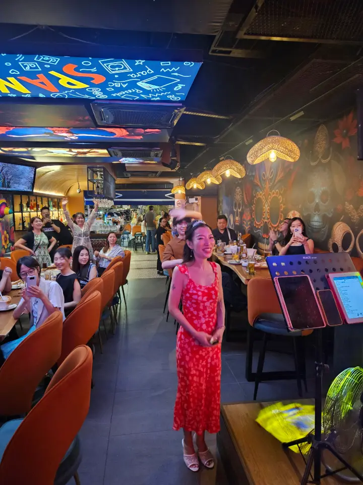 Booth seating against brick and mural under warm light